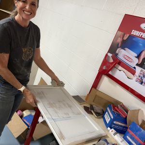 Working on refinishing a cabinet door.